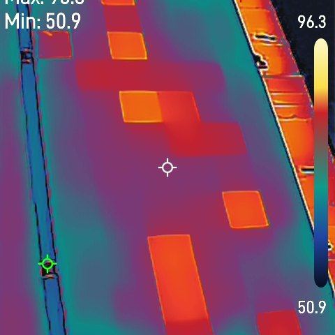 Thermal image of one solar module with several cell-sized hot squares scattered across it