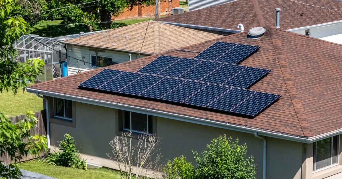 Aerial view of a Braven Solar rooftop array on a ranch home surrounded by mature trees in Northern Illinois