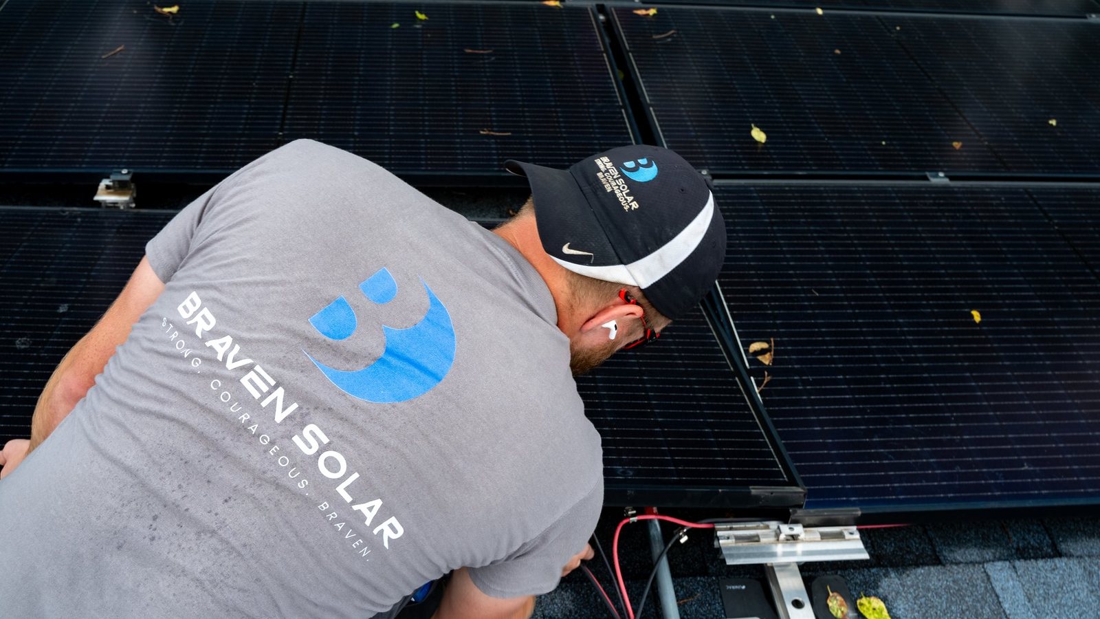 Braven Solar technician reviewing a rooftop solar system