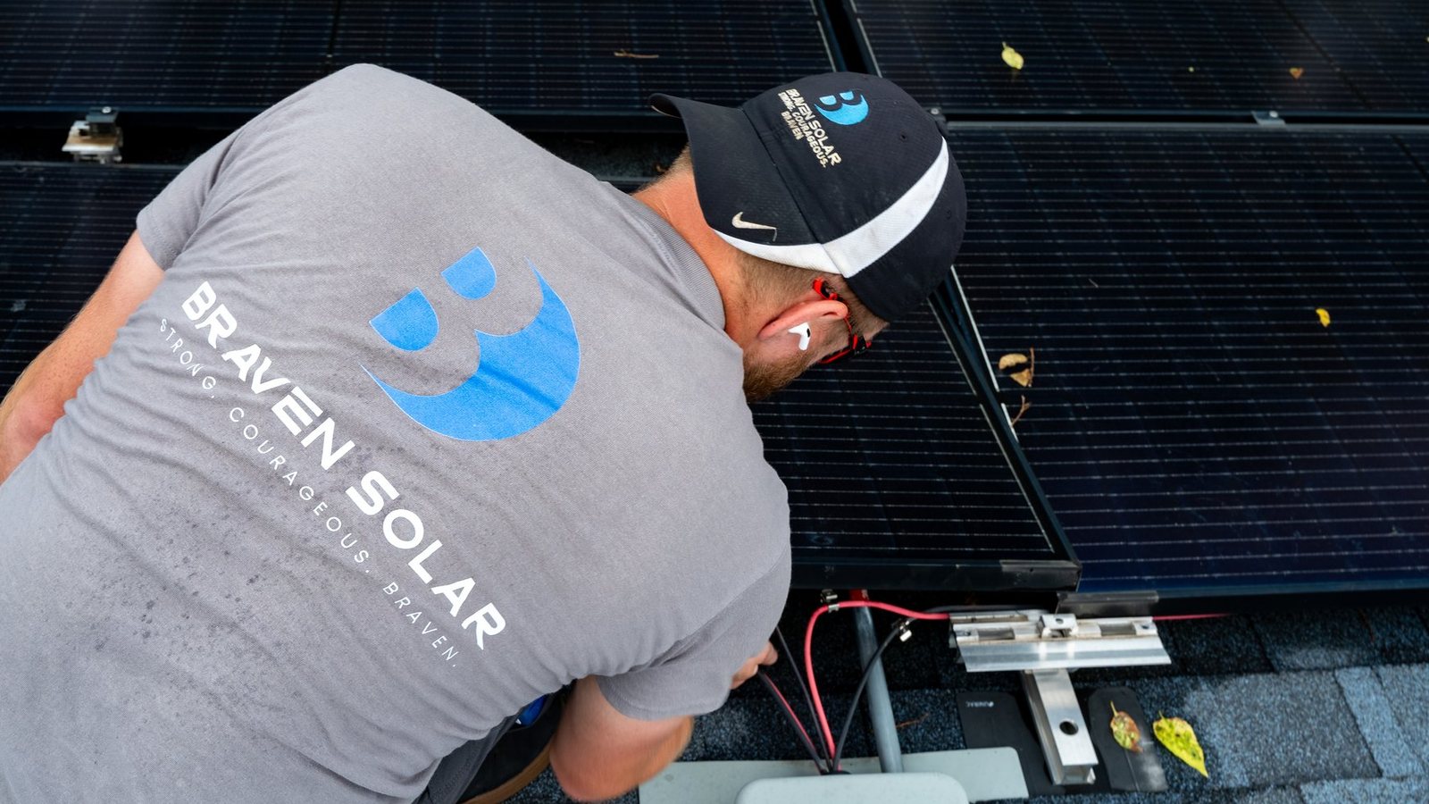 Braven Solar technician supporting a rooftop solar project