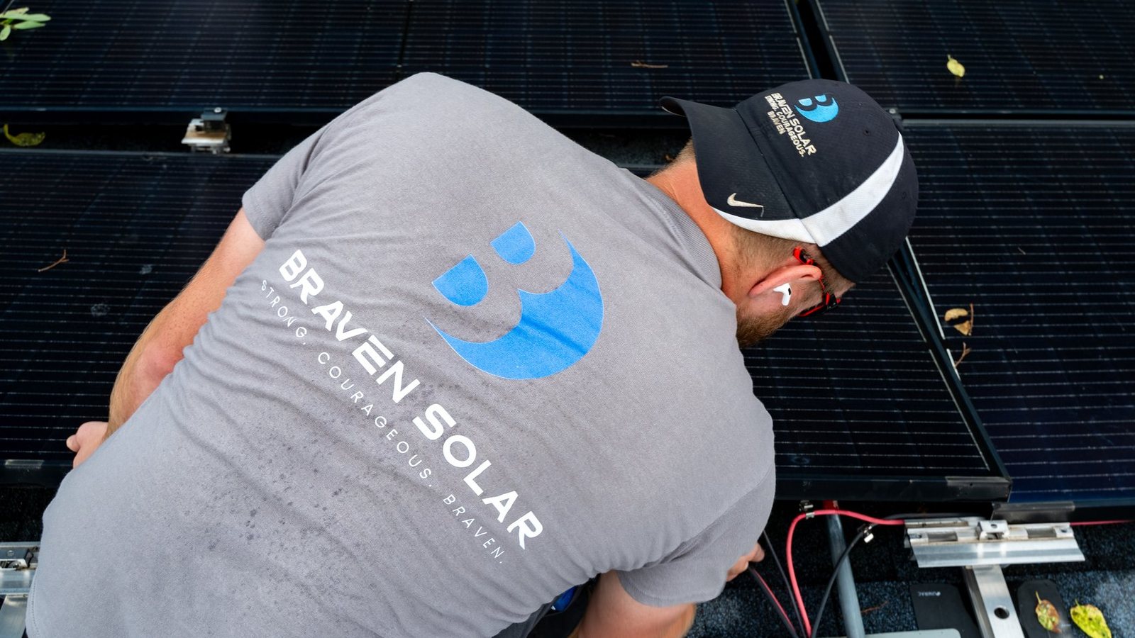 Braven Solar technician working on a rooftop solar array