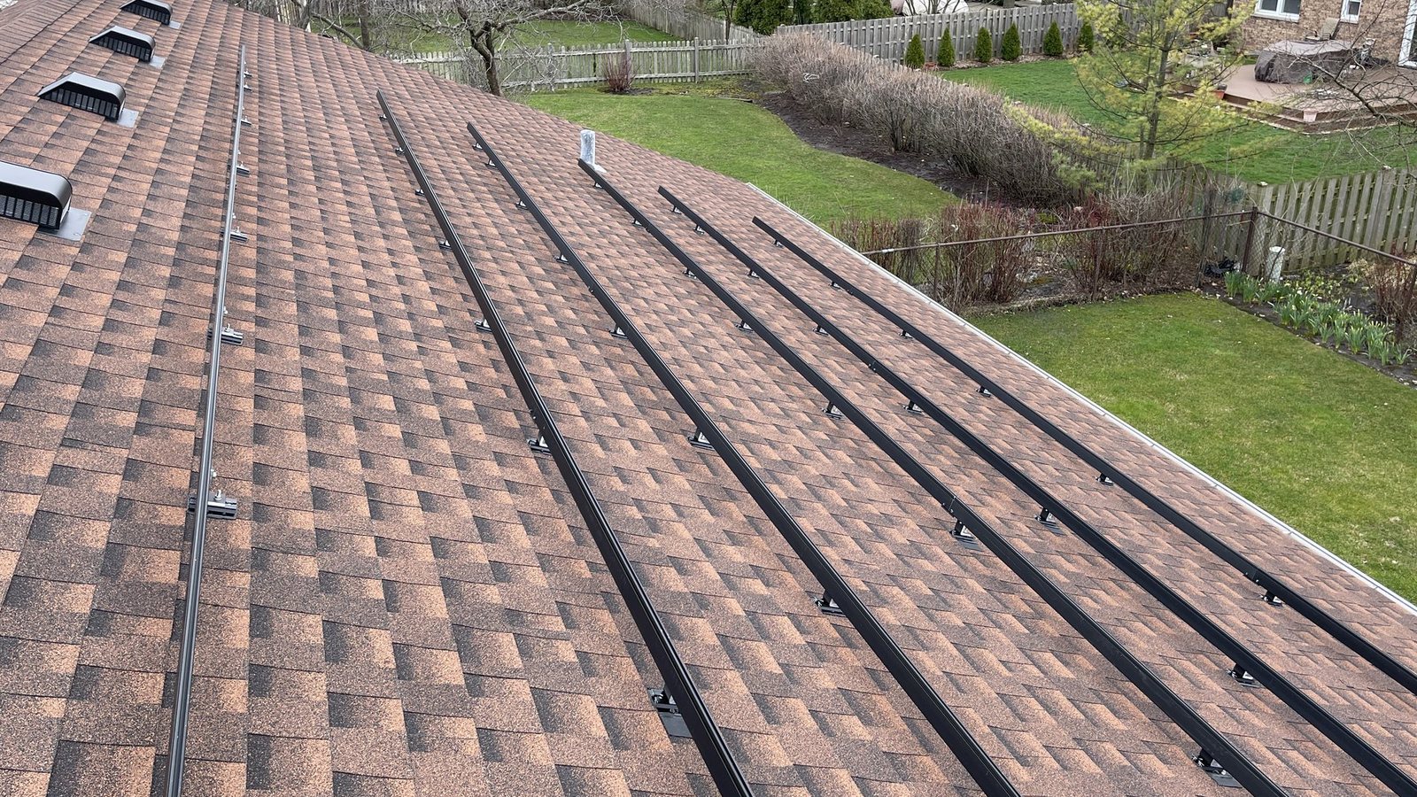 Rooftop racking rails during solar installation work