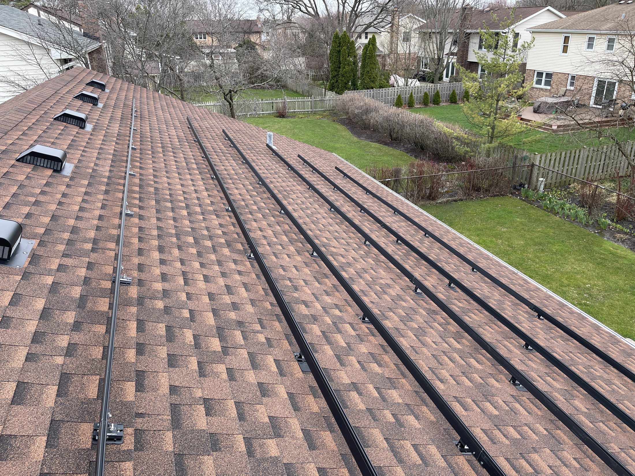 Rooftop racking rails during solar installation work