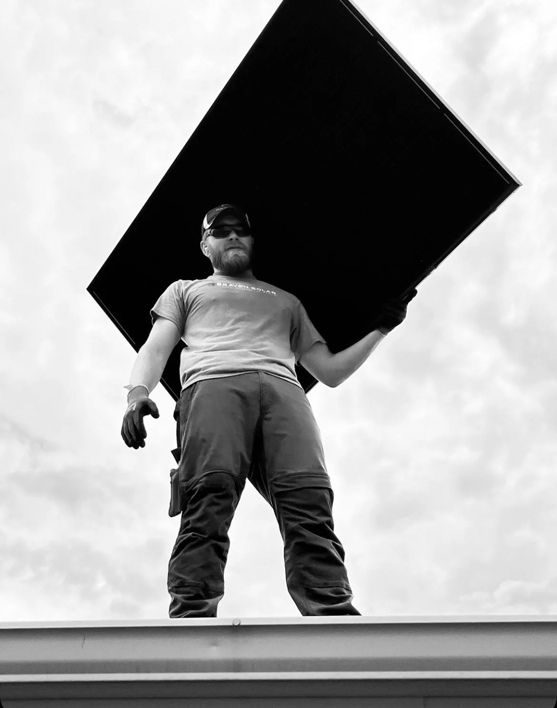 Braven Solar installer carrying a panel for residential solar service work